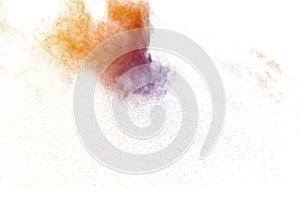 Abstract light orange powder explosion on white background. Freeze motion of light orange dust particles splash