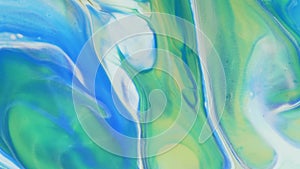 Abstract light pastel streams flow along the plane on a blue background. Marble texture. Fluid art. Liquid abstractions.