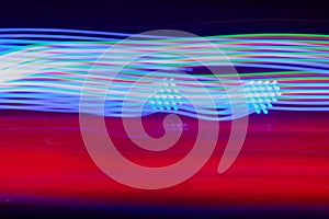 Colorful looping light trails on dark background