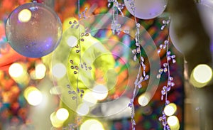 Abstract lights bokeh with colorful background and xmas hanging deco and ornaments