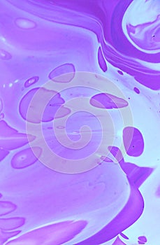 Abstract lilac marble background. Acrylic paint flows freely and creates an interesting pattern.