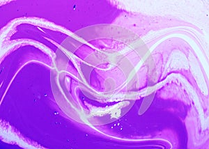 Abstract lilac marble background. Acrylic paint flows freely and creates an interesting pattern.