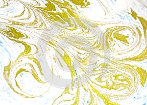 Abstract liquid gold background. Pattern with abstract golden and black waves. Marble. Handmade surface. Liquid paint. Draw, mater