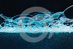 Abstract liquid soap bubbles blue background