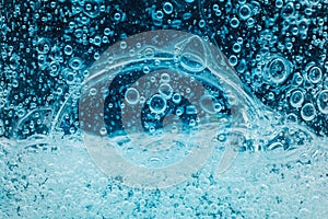 Abstract liquid soap bubbles blue background