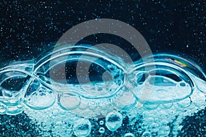 Abstract liquid soap bubbles blue background