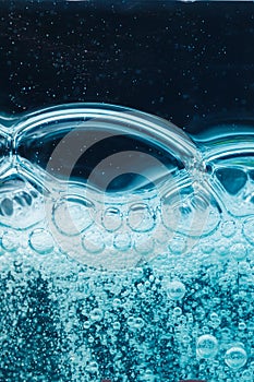 Abstract liquid soap bubbles blue background