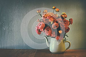 Abstract low key image of summer bouquet of flowers on the wooden table. vintage filtered image
