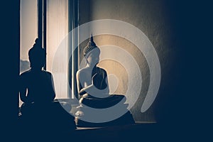 Abstract low key light image face of brass Buddha statue.