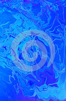 Abstract marble blue background. Acrylic paint flows freely and creates an interesting pattern.
