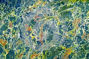 Abstract marble effect on water, called ebru. Mixed yellow,blue and green colors.