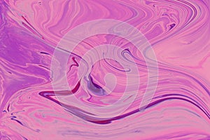 Abstract marble pink background. Acrylic paint flows freely and creates an interesting pattern.