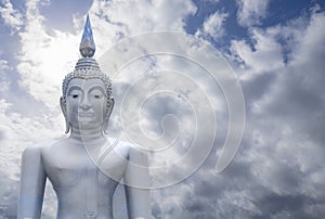 Abstract merge layer sky on image of Buddha with blue sky and cloud in background, light effect added , prachuapkhirikhan