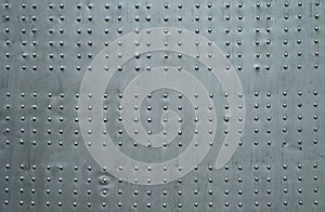 Abstract metal background. Old weathered silver metallic background. Vintage metal texture with rivets and bolts
