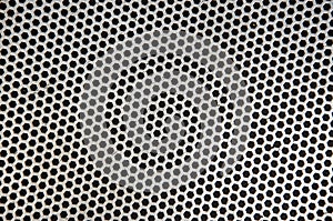 Abstract metallic perforated dark background with metal mesh effect texture.