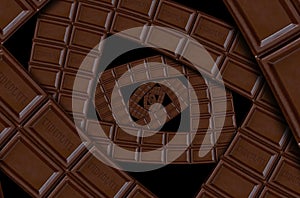 Abstract milk chocolate square spiral made of chocolate bar. Twirl abstract. Chocolate background pattern.Dark chocolate spiral