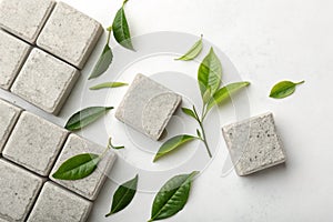 Abstract minimalist background with stone blocks and green tea leaves photo