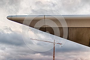 Abstract modern building corner with a large construction crane