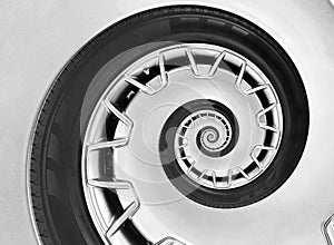 Abstract modern car wheel rim with tire twisted into surreal spiral. Automobile repetitive pattern background illustration. Car ab