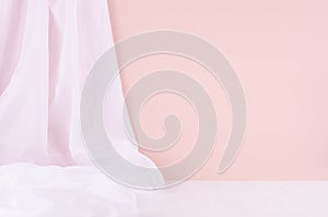 Abstract modern minimal scene or interior with soft light pastel pink wall, white silk curtain and white wood table of floor.