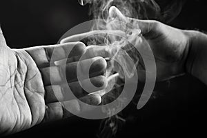 Image of hands and smoke