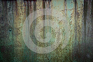 Abstract, moody wall texture background. Green and brown surface. Creative backdrop design. Rusty metal wall fragment