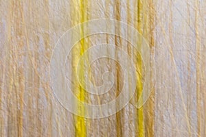 Abstract motion blur background in soft yellow and blue with vertical and diagonal lines