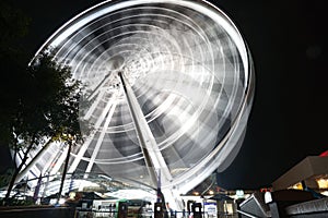 Abstract motion of rotating ferris wheel at night