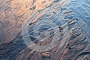 Abstract mud background with water washout trails and selective focus photo