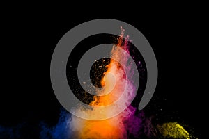 Abstract multi color powder explosion on black background.