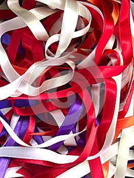 Abstract multicolor background. Texture of mixed multicolored satin thin ribbons.