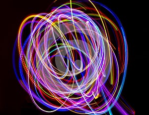 Abstract multicolored lines drawn by light on a black background
