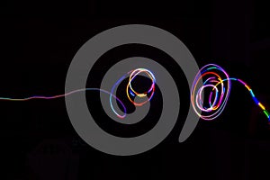 Abstract multicolored lines drawn by light on a black background