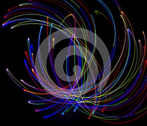 Abstract multicolored lines drawn by light on a black background