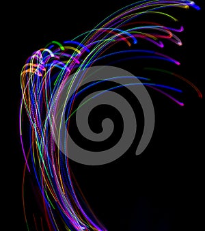 Abstract multicolored lines drawn by light on a black background