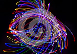 Abstract multicolored lines drawn by light on a black background
