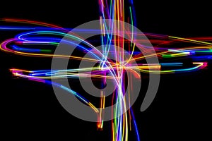 Abstract multicolored lines drawn by light on a black background