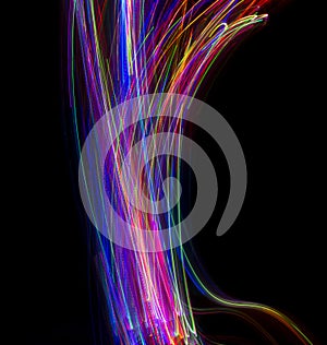 Abstract multicolored lines drawn by light on a black background