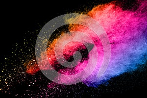 Abstract multicolored powder explosion on black background.