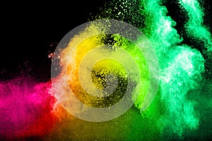 Abstract multicolored powder splatted on black background