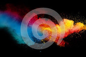 Abstract multicolored powder splatter on black background photo