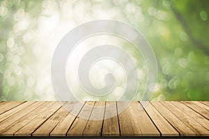 Abstract natural spring blurred garden leaves view from living room window with wooden table counter background for show, promote