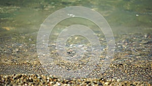 Abstract nature summer or spring ocean sea background. Small waves on golden warm water surface in motion blur with