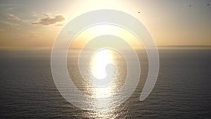 Abstract nature summer or spring ocean sea background. Small waves on golden warm water surface in motion blur with