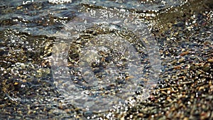 Abstract nature summer or spring ocean sea background. Small waves on water surface in motion blur with bokeh lights