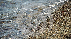 Abstract nature summer or spring ocean sea background. Small waves on water surface in motion blur with bokeh lights