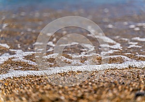 Abstract nature summer or spring ocean sea background. Small waves on water surface in motion blur with bokeh lights from sunrise