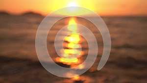 Abstract nature sunset or sunrise ocean sea Blur and bokeh light background.Waves in motion blur with bokeh lights from sunset .Ho