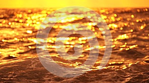 Abstract nautical summer ocean sunset background with blurred waves, sun reflections, and bokeh. Seamless panorama and