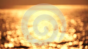 Abstract nautical summer ocean sunset background with blurred waves, sun reflections, and bokeh. Seamless panorama and